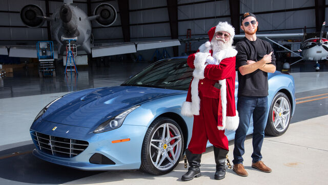 Santa poses in front of his new sleigh, the Ferrari California