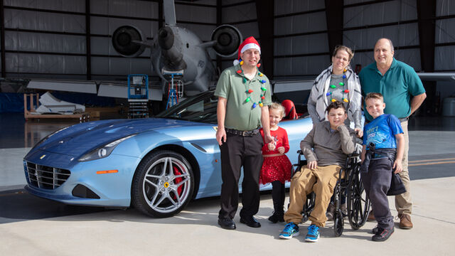 The Zazza family takes a photo in front of the Ferrari California