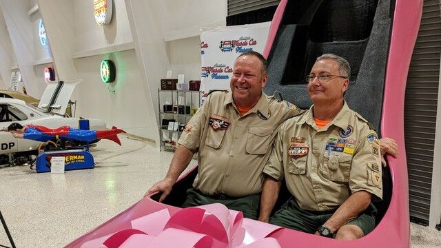 Scoutmasters at Boy scout Troop 323 tour take a turn in the giant shoe