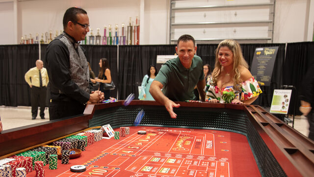 Rolling the dice for Craps at the Candlelighters of Brevard Cars and Casino Night