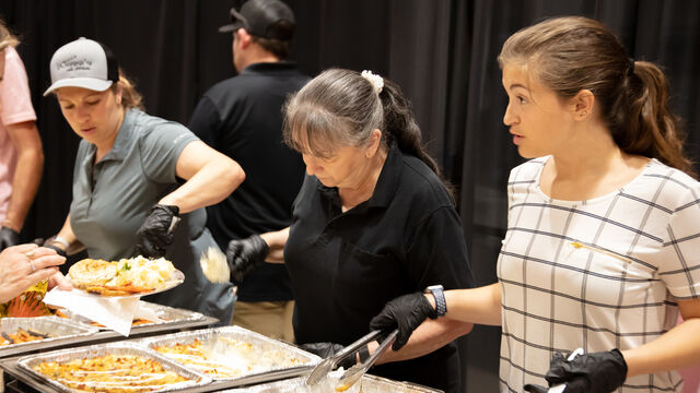 Serving up food for attendees at the Candlelighters of Brevard Cars and Casino Night