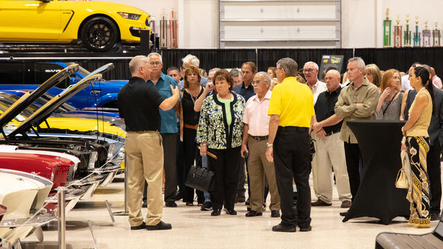 Discussing cars at the Candlelighters of Brevard Cars and Casino Night