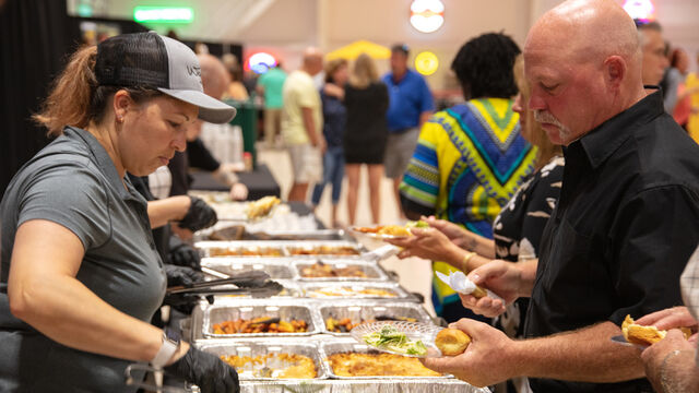 Serving up food for attendees at the Candlelighters of Brevard Cars and Casino Night