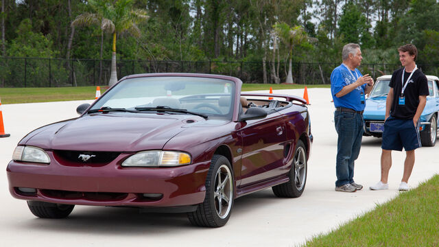 Discussing next to a newer Ford Mustang at the Hagerty Youth Driving Experience