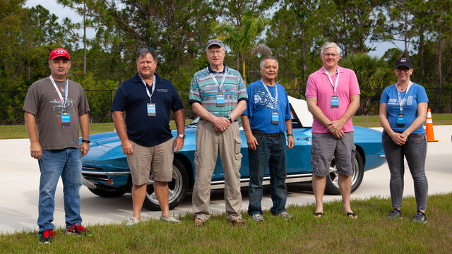 Taking a photo in front of one of the many vintage cars on display at the Hagerty Youth Driving Experience