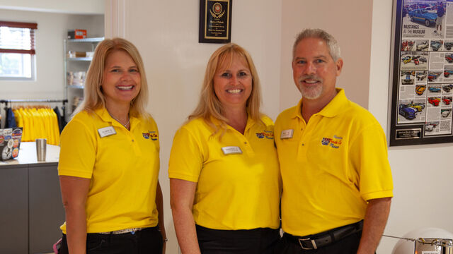 American Muscle Car Museum staff stop for a photo