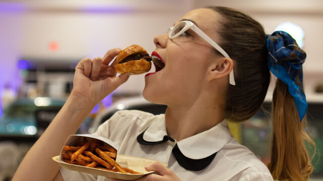 A waitress pretends to eat a slider at the Health First 35th Celebration of Giving Event