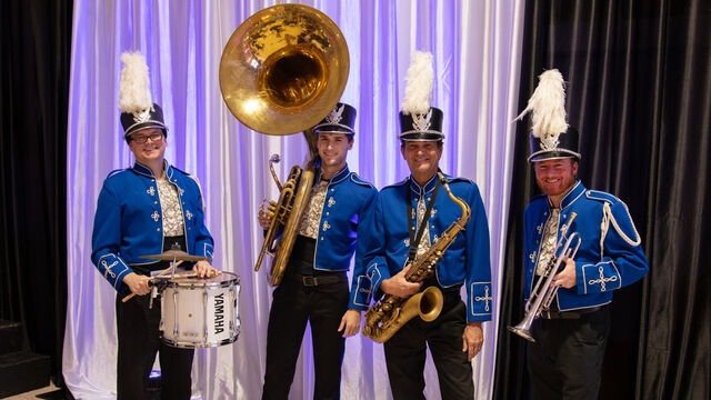 The marching band poses for a photo
