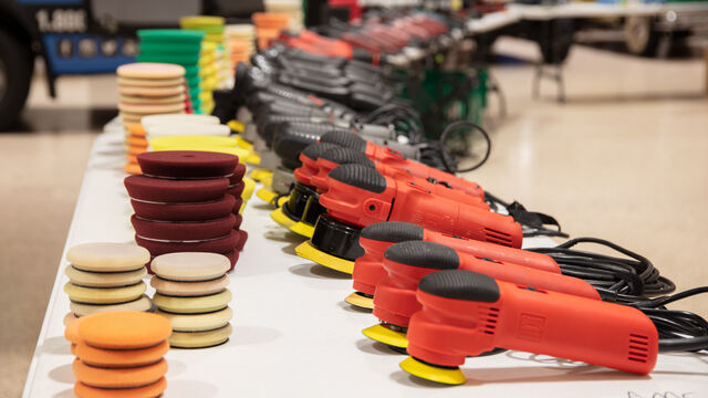 Polishers and pads line the table ready for attendees