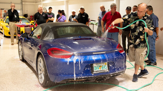 Rinsing off the car after a washing demonstration at the Porsche Club of America Detail Class