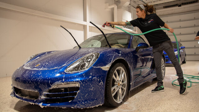 Rinsing the soap off a newly-washed car at the Porsche Club of America Detail Class