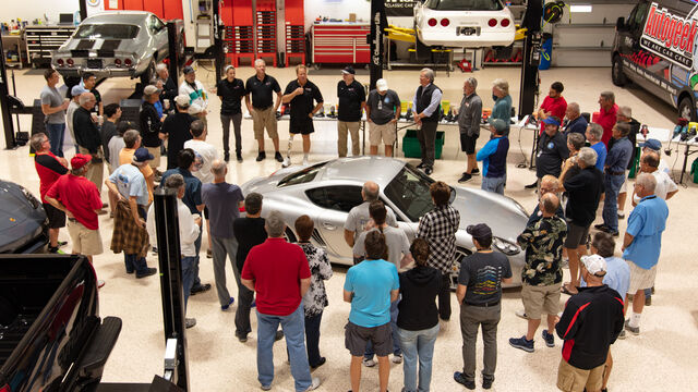 Gathering around the guinea pig car at the Porsche Club of America Detail Class