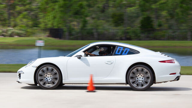 White Porsche 00 driving the track at the Porsche Club of America (PCA) Autocross 