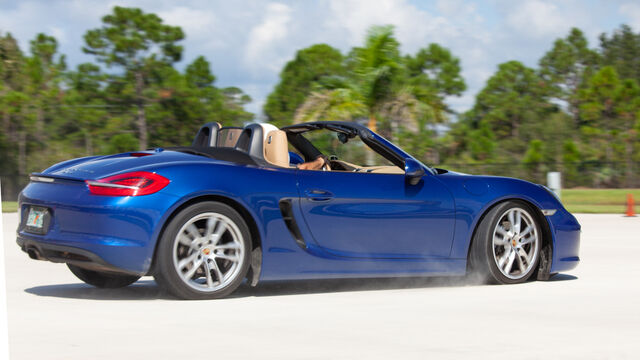 A blue Porsche kicks up dust at the Porsche Club of America (PCA) Autocross 