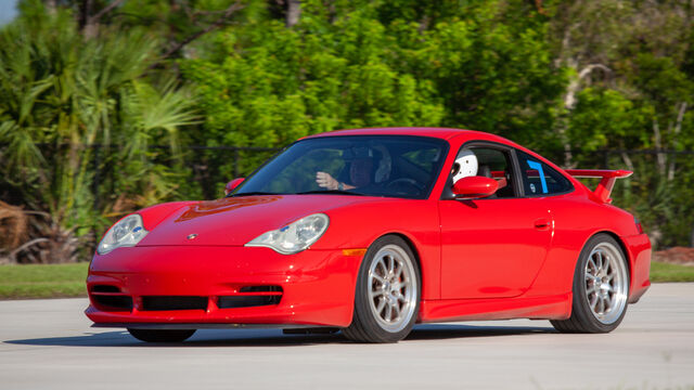 The red Porsche goes over the track