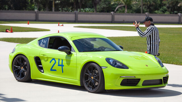 Green Porsche number 24 going over the rules at the Porsche Club of America (PCA) Autocross 