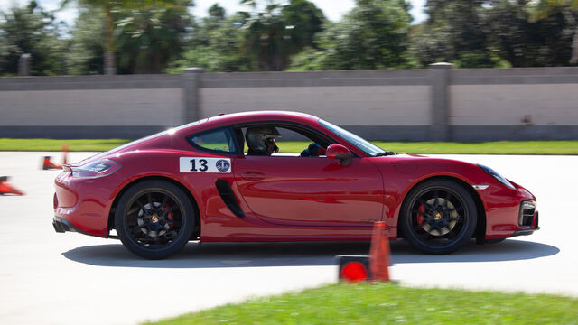 Red Porsche number 13 driving at the Porsche Club of America (PCA) Autocross 