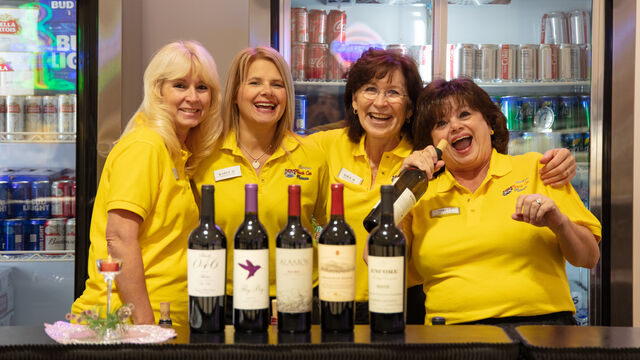 American Muscle Car Museum staff man the bar at the Satellite High School Instrumental Fundraiser