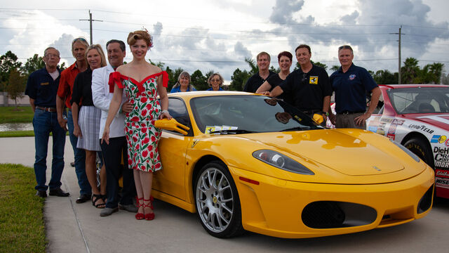Posing with a Ferrari at the Space Coast Honor Flight Event