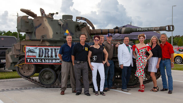 Taking a photo with a tank at the Space Coast Honor Flight Event