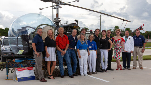 Taking a photo with a helicopter at the Space Coast Honor Flight Event