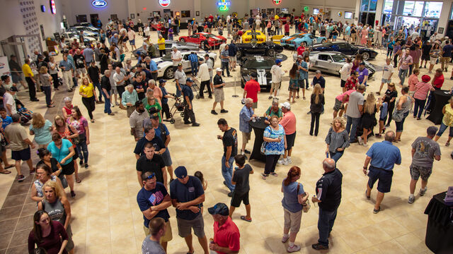 Attendees at the Veteran's Day Open House check out some of the cars on display