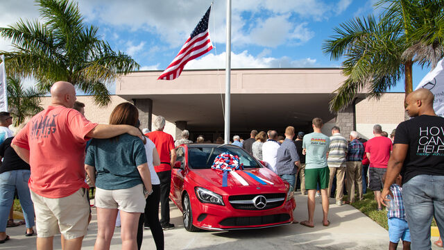 A Mercedes Benz parked outside the main entrance to the Veteran's Day Open House