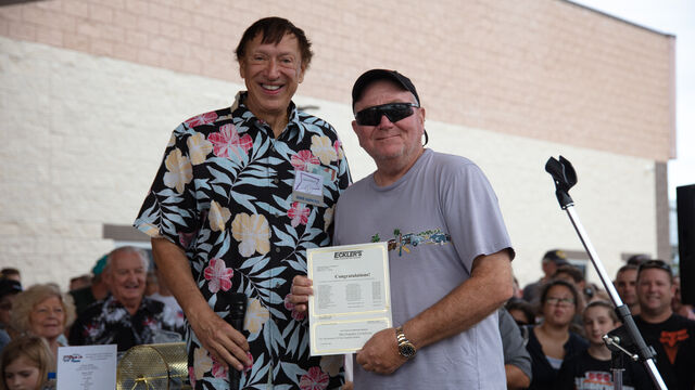 Giving out a merchandiser certificate 