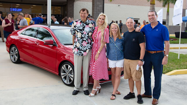Standing next to the red car at the Veteran's Day Open House